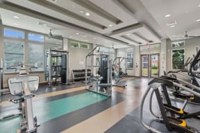 a gym with weights and cardio equipment at the estates at johnsons crossing