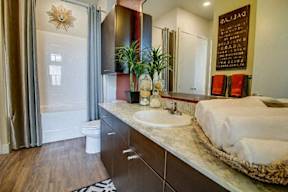 a bathroom with a bed and a sink and a toilet