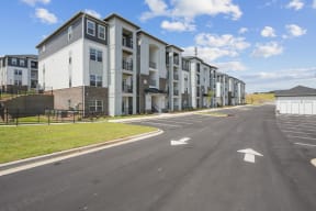 an empty street in front of an apartment building