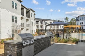 the preserve at ballantyne commons stainless steel barbecue grill on patio with apartment buildings