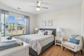 a bedroom with a bed and a ceiling fan
