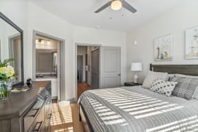a bedroom with a large bed and a ceiling fan