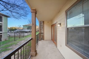 the view from the balcony of a home with a large window