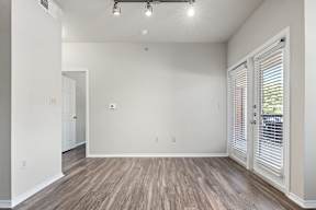 A room with wooden floors and white walls.