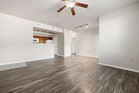 A room with a ceiling fan and lighting fixtures.