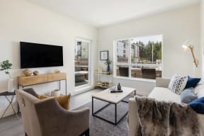 a living room with a couch and a chair and a television