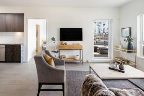 a living room with a couch and a chair and a television