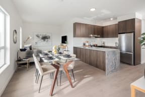 a kitchen and dining room with a table and chairs