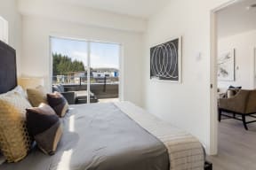 a bedroom with a large bed and a door to a balcony