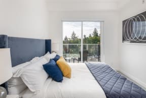 a bedroom with a large bed and a large window