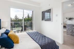 a bedroom with a large bed and a sliding glass door
