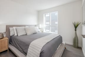 a bedroom with a large bed and a window