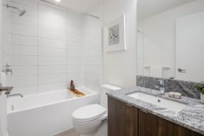 a bathroom with a tub and a toilet and a sink