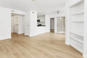 A white room with wooden floors and white walls.