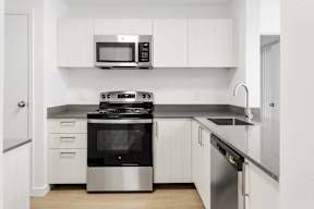 A modern kitchen with a stainless steel oven and microwave above the stove.