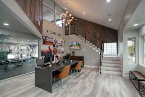 A home office with a staircase leading to the upper floor.