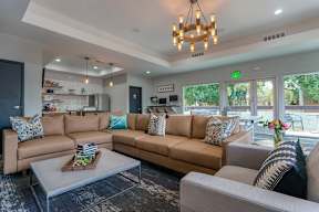 A living room with a brown couch and a coffee table.