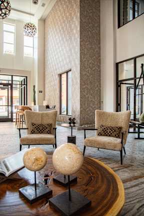 A living room with a globe and two chairs.