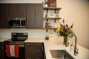 A kitchen with a stove, oven, and sink.