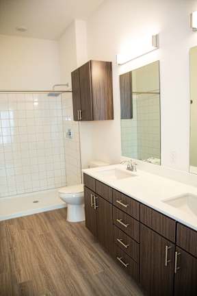 A white sink is on a countertop in a bathroom.