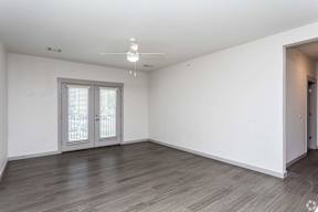 A room with a sliding door and a window with blinds.