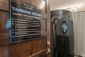 A sign in a room warning of the dangers of tanning.