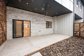 A modern house with a black ceiling fan and a glass door.