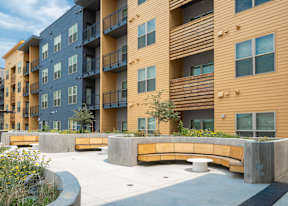 A modern apartment complex with a courtyard and landscaping.