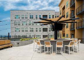 A patio with a table and chairs under a canopy.