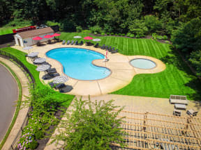 an aerial view of a pool and a backyard with chairs and umbrellas at Atlantic Pointe Apartments, Atlantic Highlands, New Jersey