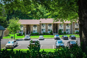 a parking lot with cars in front of an apartment building at Atlantic Pointe Apartments, Atlantic Highlands, New Jersey