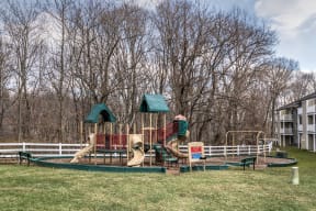 a playground with a swing set and slides at Ellicott Grove, Ellicott City
