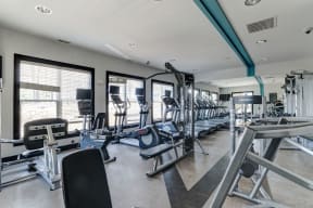 a large fitness room with cardio equipment and windows at Ellicott Grove, Ellicott City Maryland