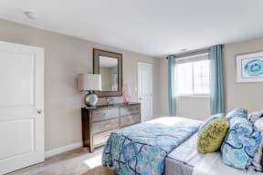 a bedroom with a bed and a dresser with a mirror at Ellicott Grove, Ellicott City