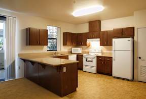 a kitchen with brown cabinets and white appliances and a counter top