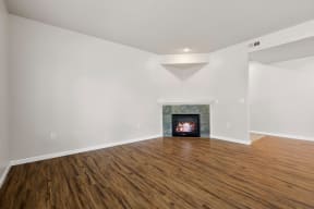 a living room with a fireplace and wooden floors