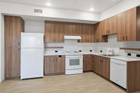 A modern kitchen with wooden cabinets and white appliances.