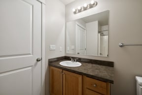 an empty bathroom with a sink and a mirror