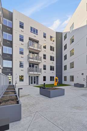 A modern building with a playground in front.