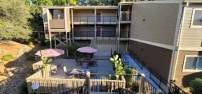 an aerial view of an apartment building with tables and umbrellas