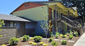 A modern house with a red, green, and yellow exterior.