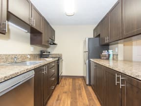 a kitchen with stainless steel appliances and marble counter tops