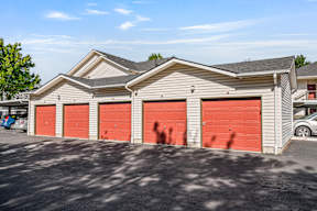A two-story building with red garage doors.