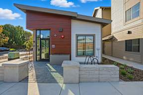 A modern house with a red and white exterior and a glass door.