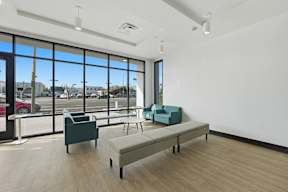 A room with a large window and a view of a parking lot.