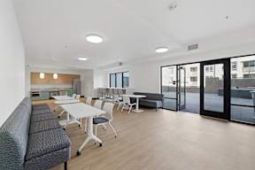 A conference room with a long table and chairs.