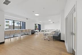 A conference room with a long table and chairs.