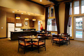 a dining room and kitchen with a table and chairs