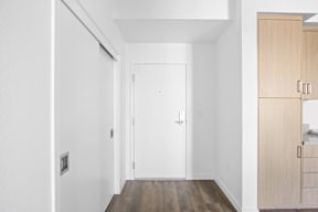 A white door is in the middle of a hallway.