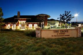 the grove at sunset sign in front of home at night
